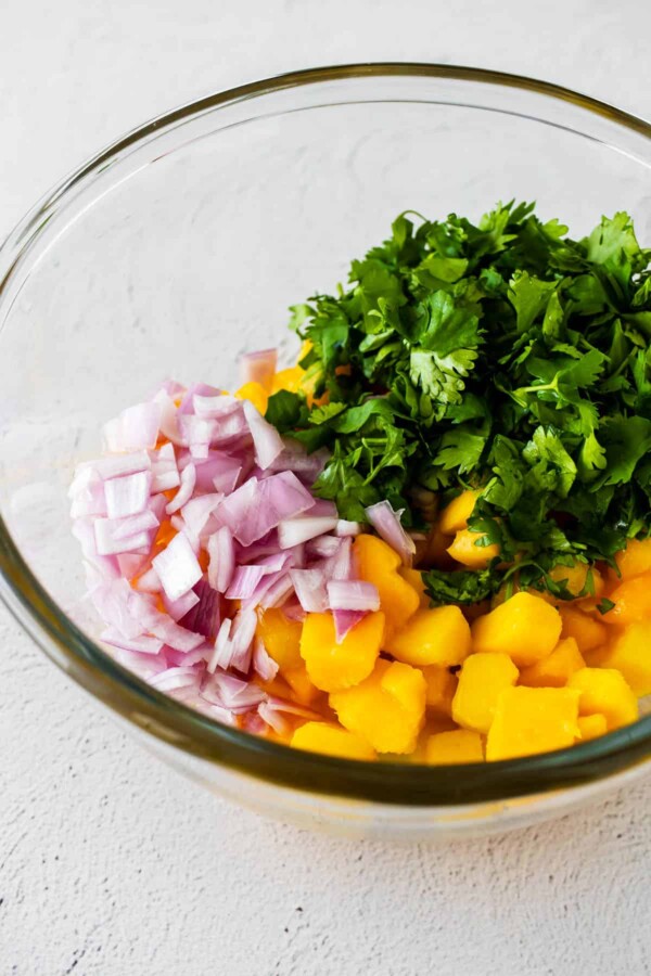 mango salsa ingredients in a glass bowl