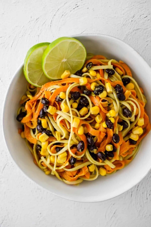 overhead shot of sweet potato noodles with avocado sauce in a bowl