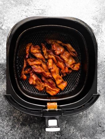 overhead view of bacon in an air fryer basket