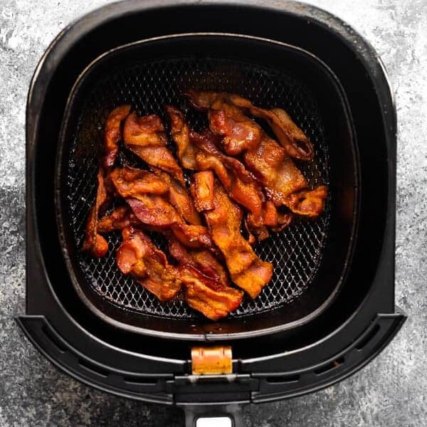 overhead view of bacon in an air fryer basket