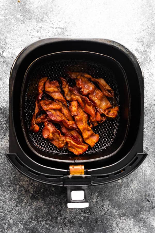 overhead view of bacon in an air fryer basket