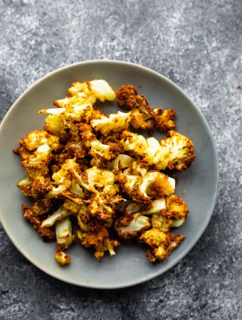 overhead shot of Crispy air fryer cauliflower in gray bowl