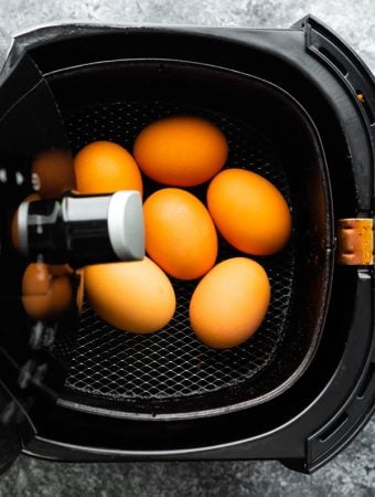 overhead view of eggs in an air fryer basket