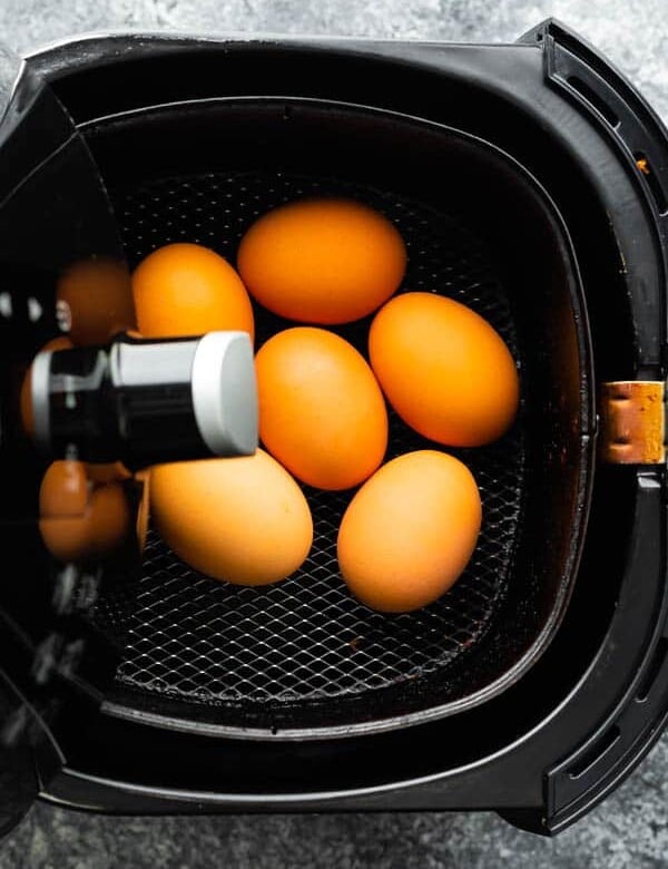overhead view of eggs in an air fryer basket