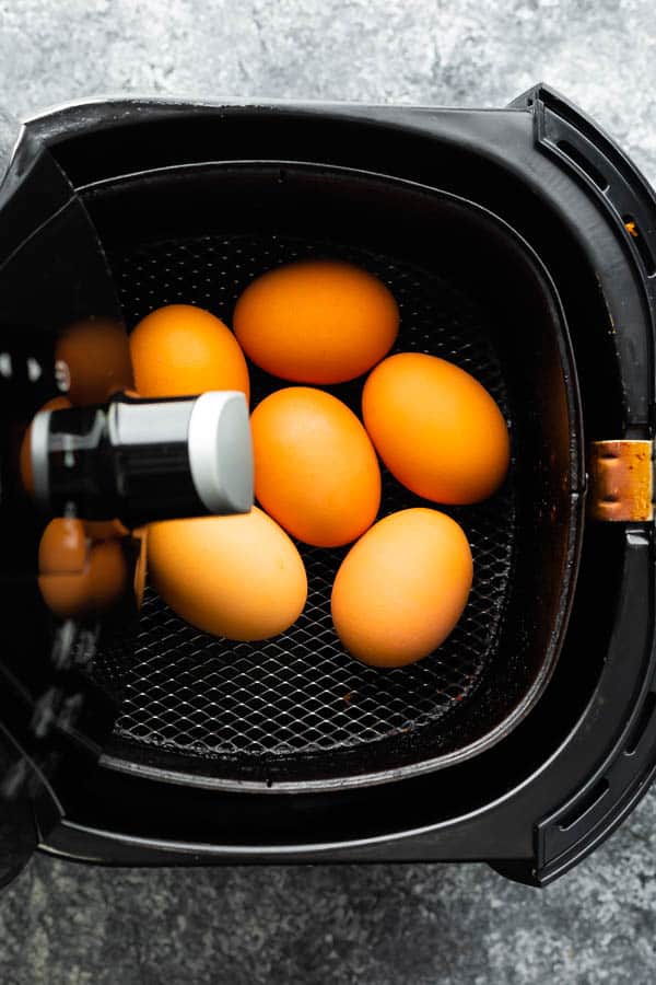 overhead view of eggs in an air fryer basket
