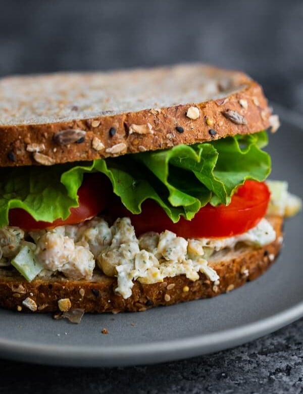close up view of chickpea salad sandwich on plate
