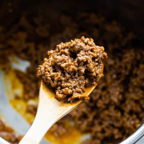 Close up shot of instant pot taco meat on a wooden spoon