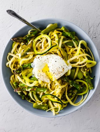 overhead view of spiralized pasta with egg in bowl