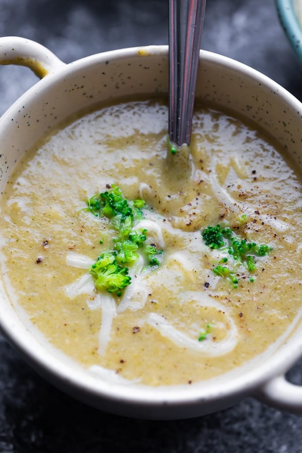 close up shot of broccoli soup in a bowl with a spoon