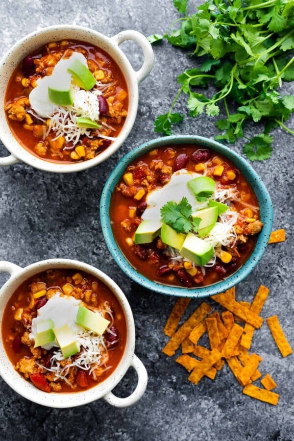 overhead view of three bowls of instant pot turkey chili