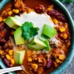 instant pot turkey chili in a bowl with toppings and spoon