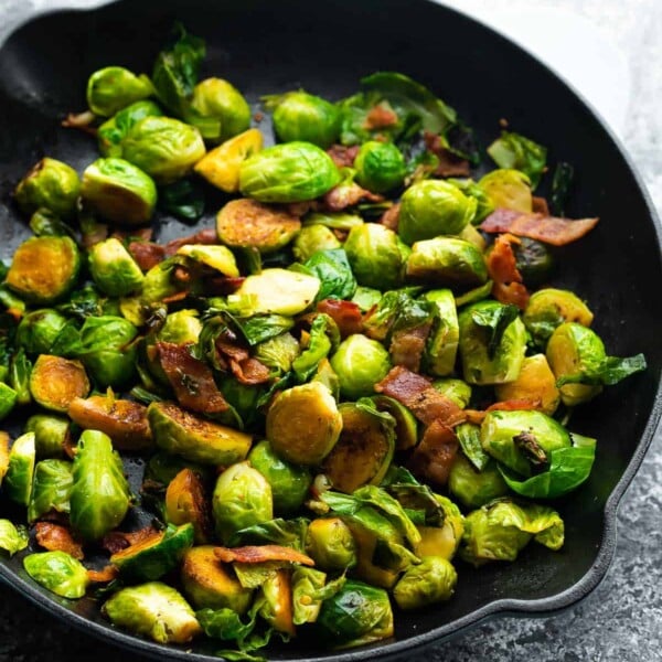 side angle view of brussels sprouts with bacon in a skillet