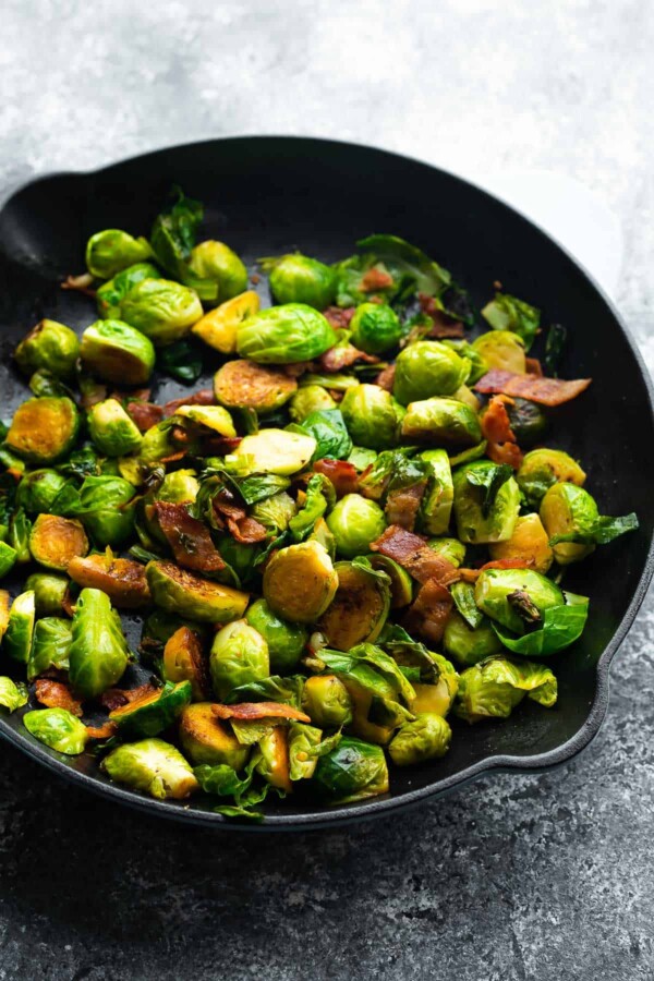 side angle view of brussels sprouts with bacon in a skillet