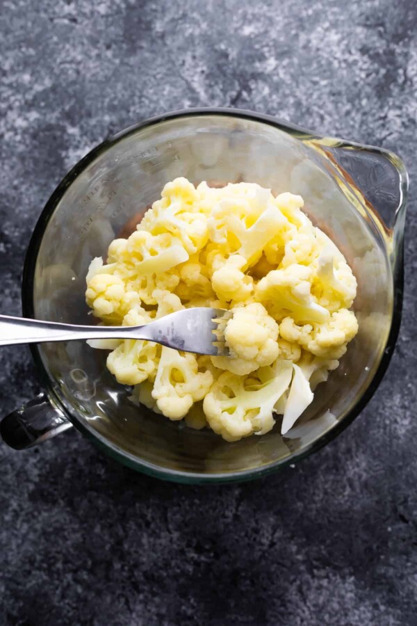 steamed cauliflower in large glass measuring dish