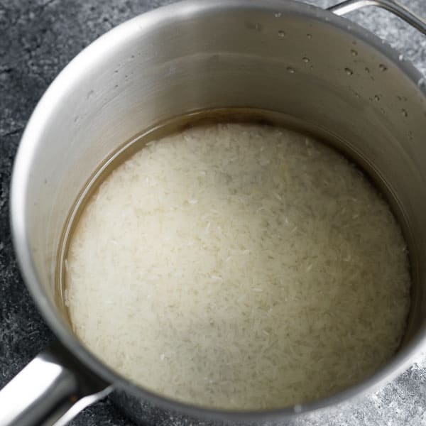 rice in clear water after rinsing