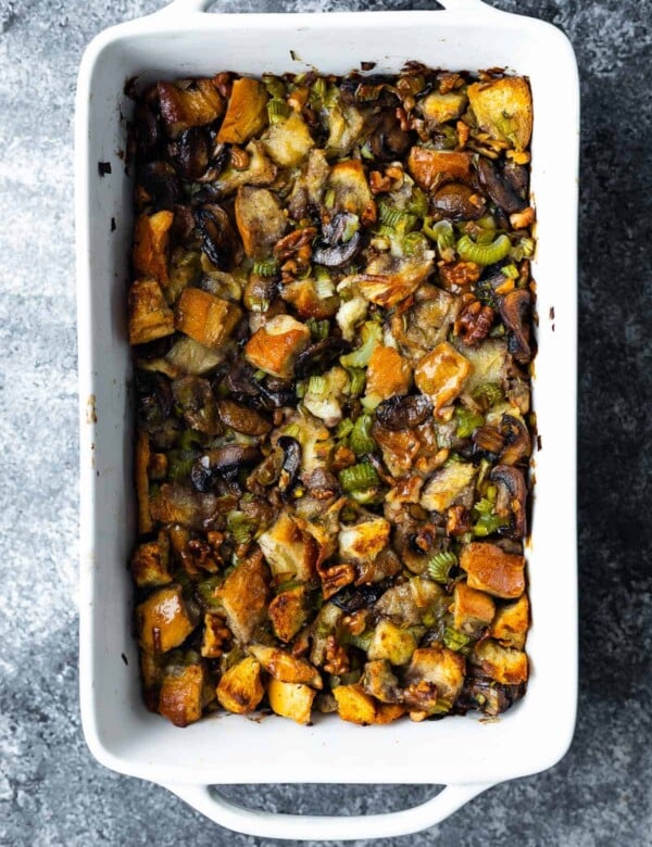overhead view of leek and mushroom stuffing in white casserole dish