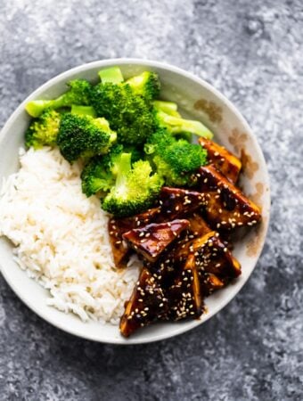 overhead view of teriyaki tofu in bowl with rice and broccoli