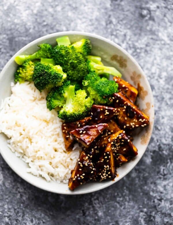 overhead view of teriyaki tofu in bowl with rice and broccoli