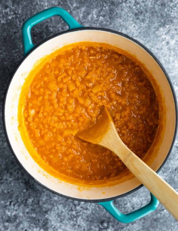thai lentil curry in blue pot with spoon