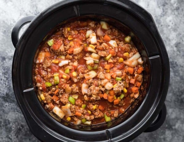 overhead view of uncooked turkey chili in slow cooker