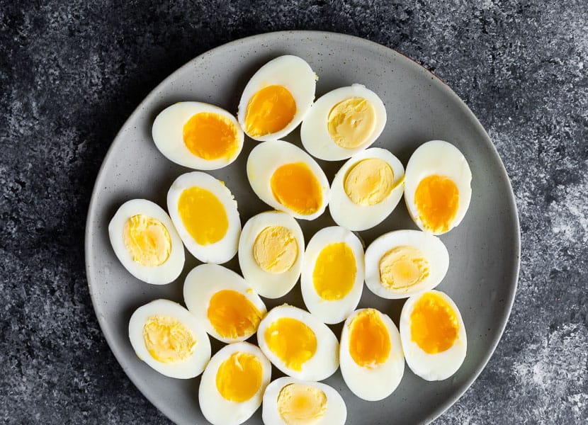 overhead of hard and soft boiled eggs on grey plate