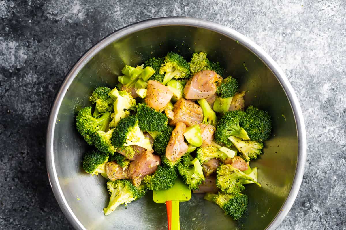 lemon pepper chicken and broccoli mixed up in silver bowl