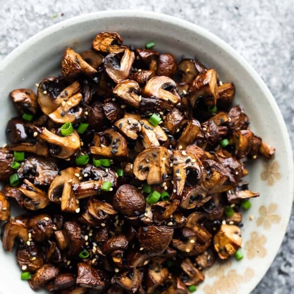 air fryer mushrooms in a bowl with sesame seeds and green onions