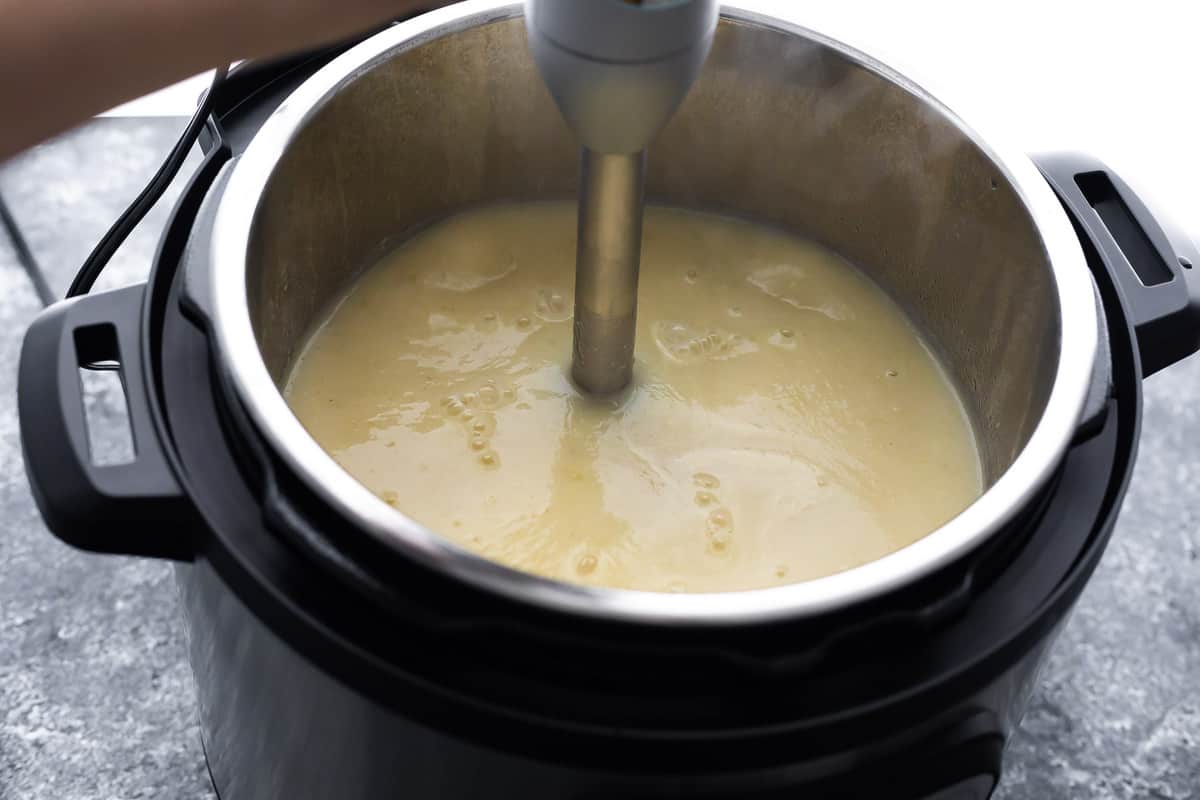pureeing cauliflower cheese soup in the instant pot using an immersion blender