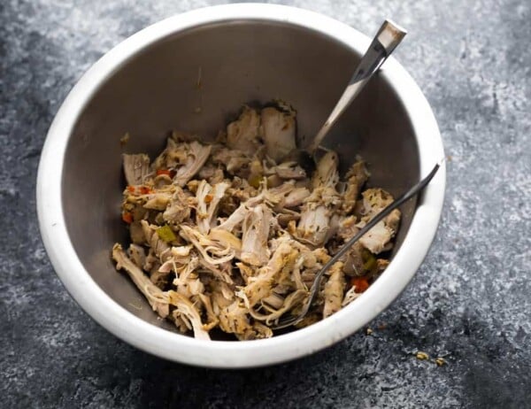 shredded chicken in a bowl with forks