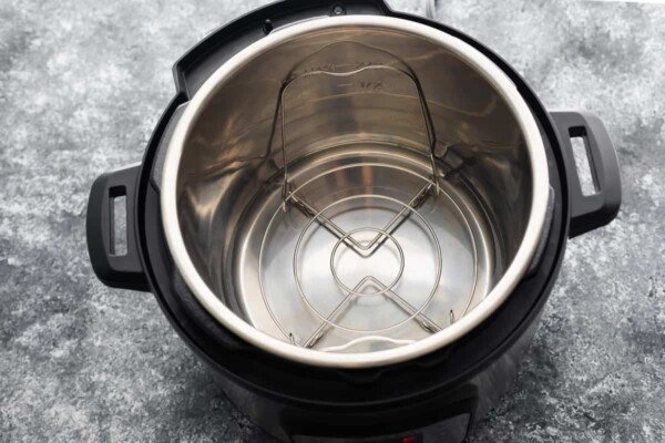 instant pot with water and trivet in the insert
