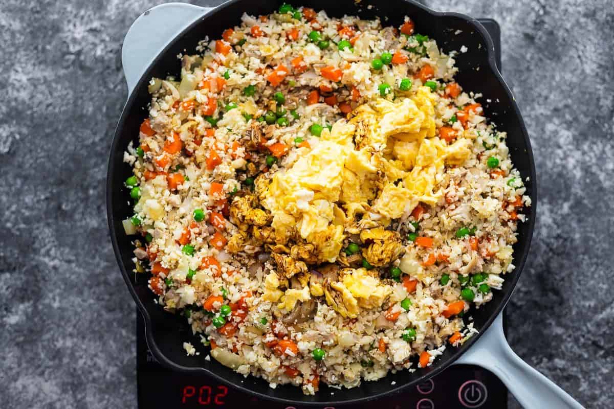 cauliflower fried rice with scrambled eggs and soy sauce added on top