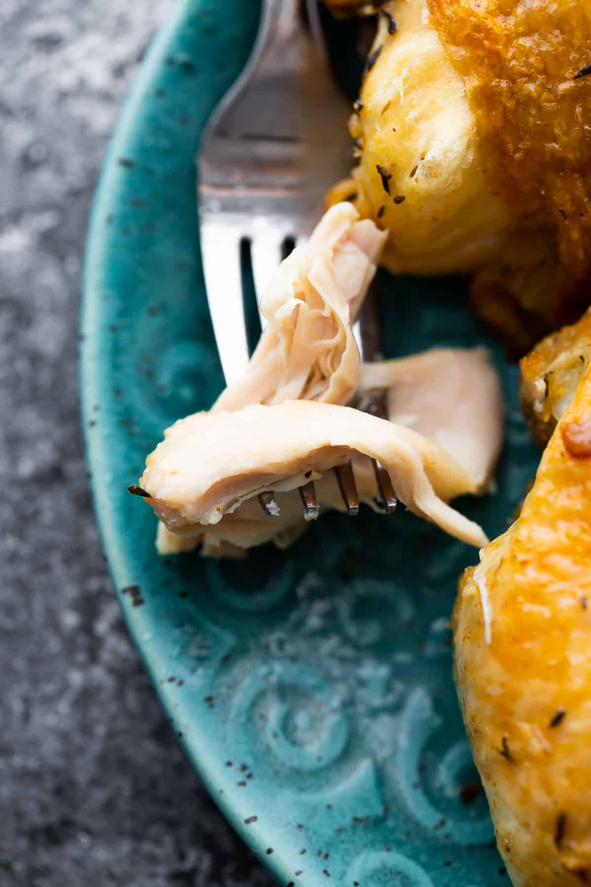 close up shot of chicken thigh meat on a fork