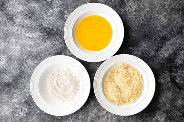 three bowls with flour, eggs, and panko