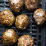 close up shot of meatballs in air fryer basket