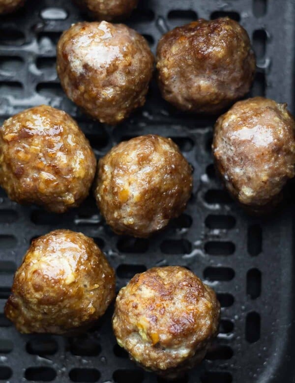 close up shot of meatballs in air fryer basket