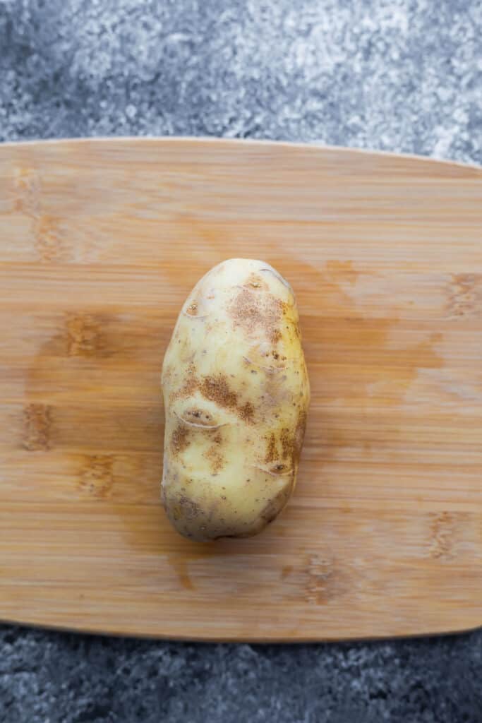 russet potato on cutting board