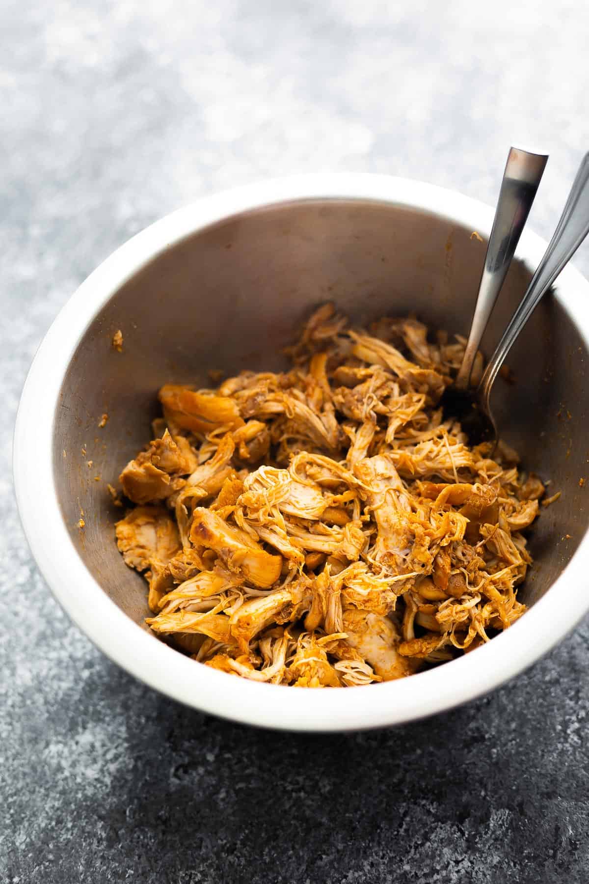 shredded chicken in bowl with forks