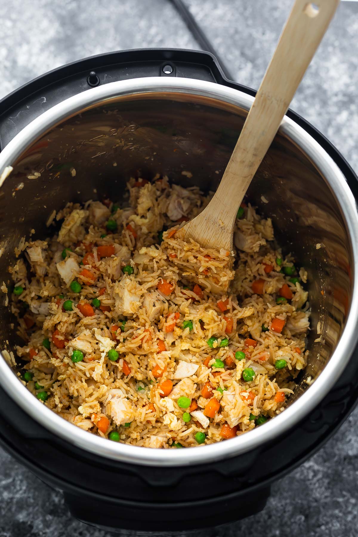 fried rice in instant pot with wooden spoon