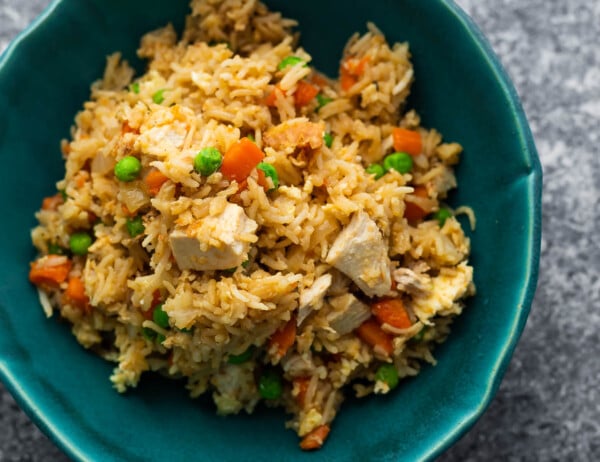overhead view chicken fried rice in blue bowl