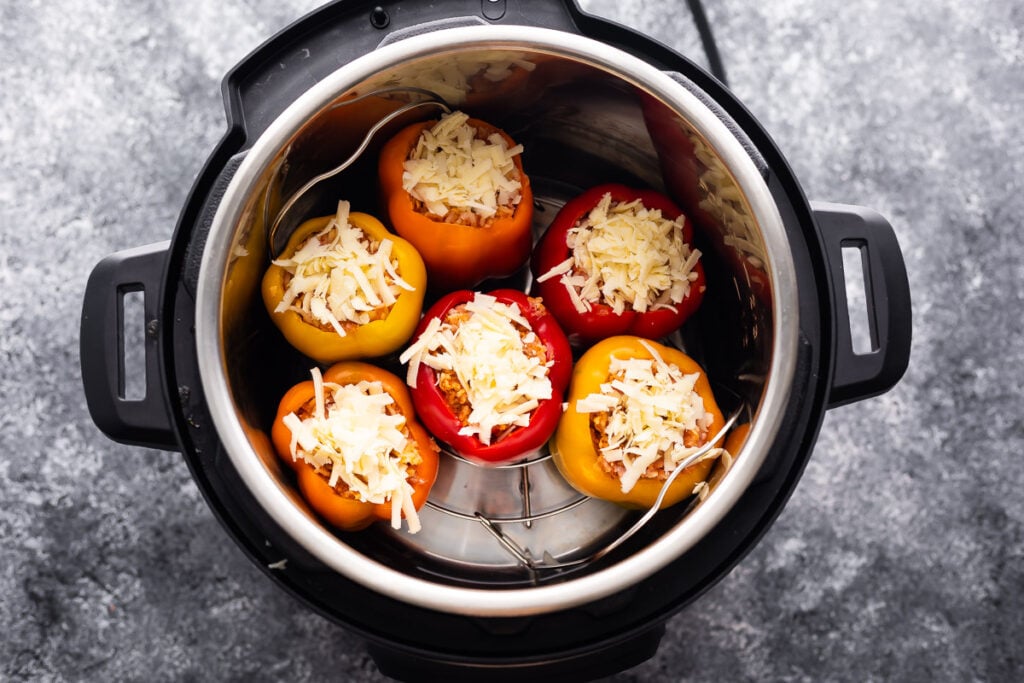 stuffed peppers in instant pot with cheese on top- uncooked