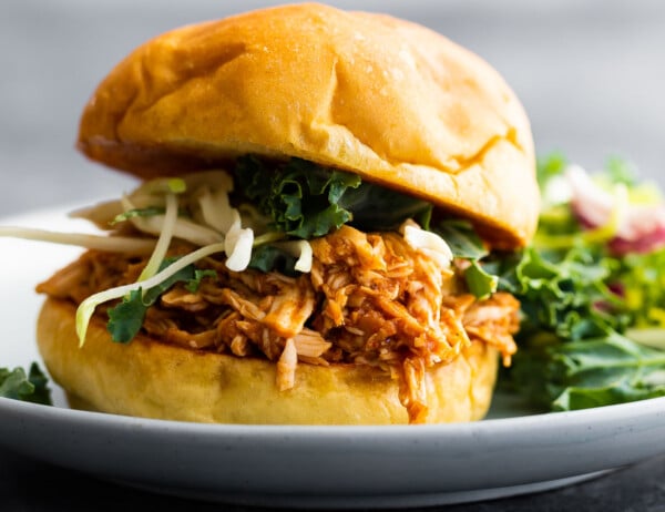 side angle view of bbq chicken sandwich on plate