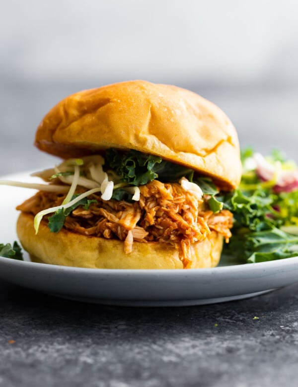 side angle view of bbq chicken sandwich on plate