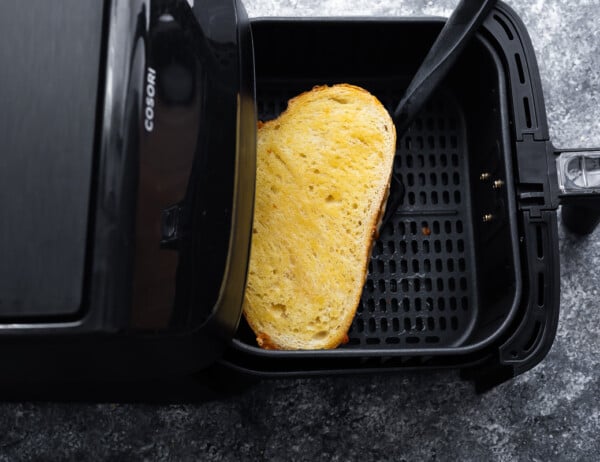 flipping the grilled cheese over in air fryer basket