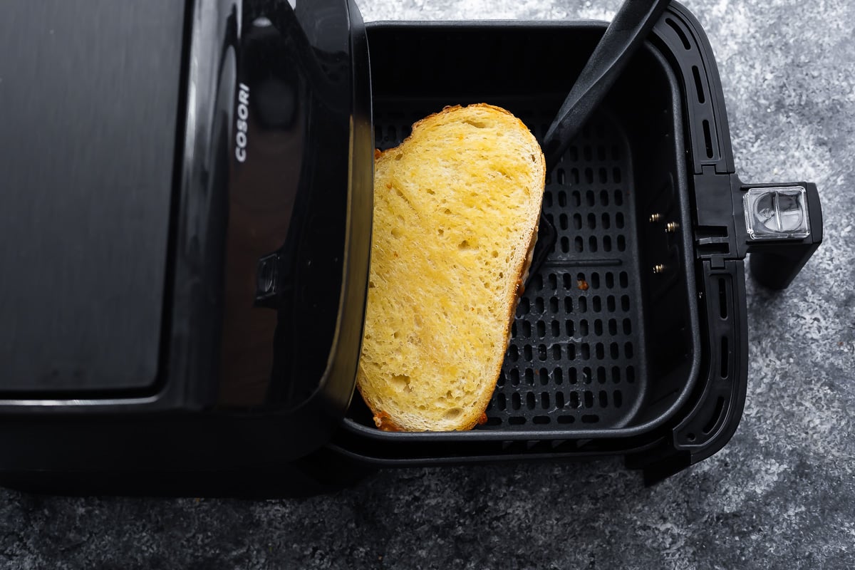 flipping the grilled cheese over in air fryer basket