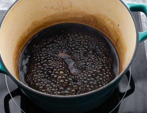 balsamic reduction simmering in blue pot