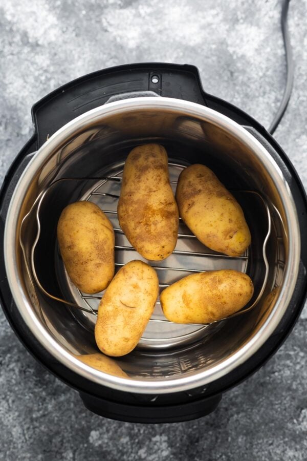overhead view of 5 potatoes in instant pot before cooking
