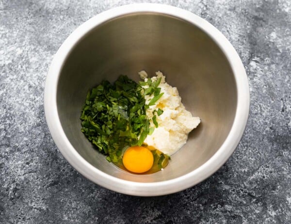 ricotta, basil, egg and salt in bowl