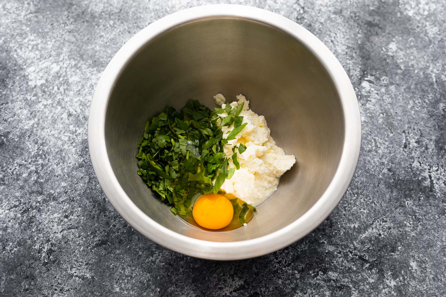 ricotta, basil, egg and salt in bowl