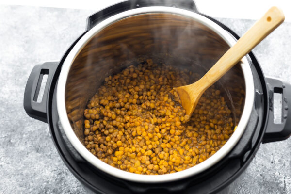 cooked green lentils in instant pot with spoon