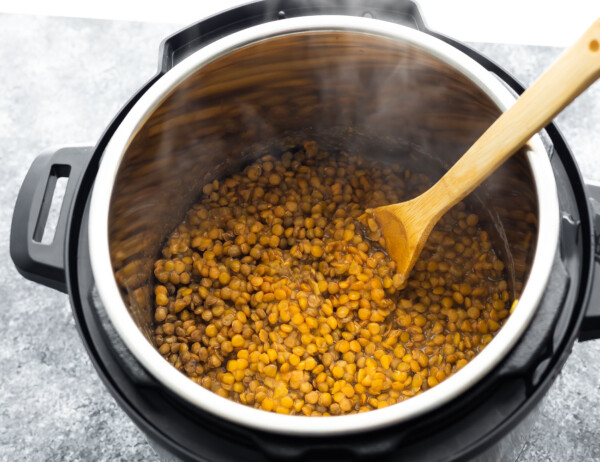cooked green lentils in instant pot with spoon